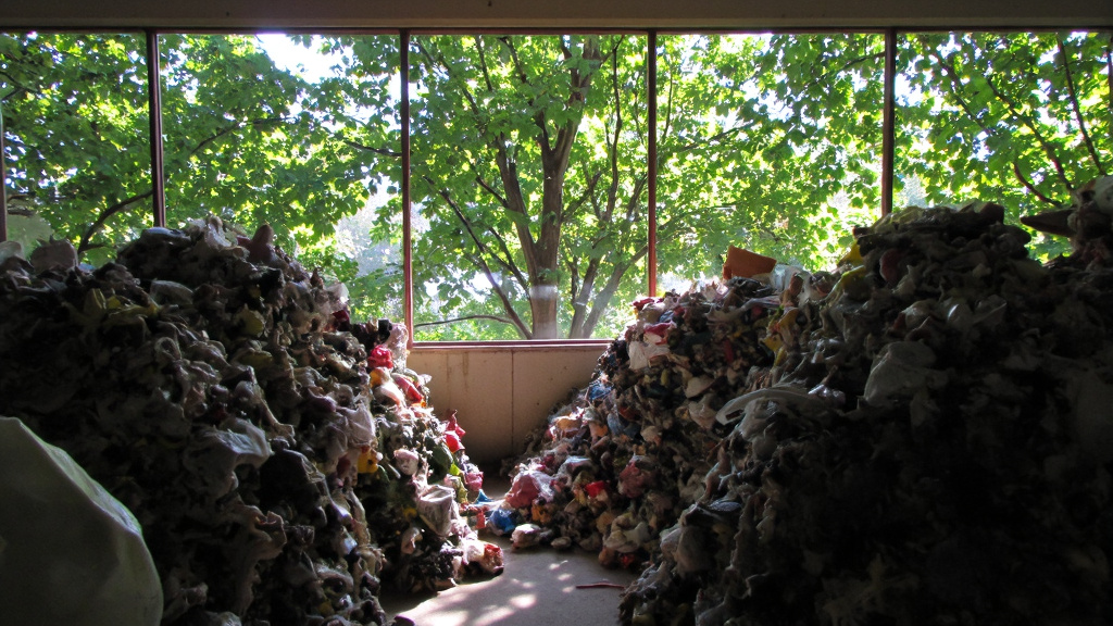 Eco-Friendly Recycling Center Eco-friendly recycling center with sorted AC materials and green trees visible.