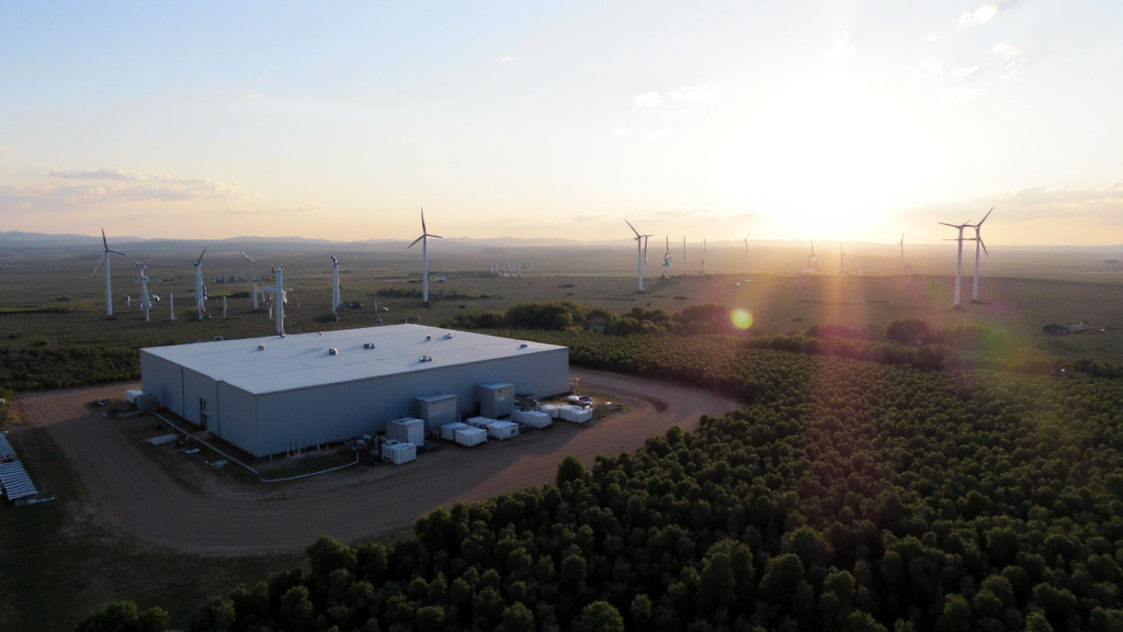 Magnetic Energy Storage with Renewable Energy Sources Large-scale magnetic energy storage facility next to solar panels and wind turbines in evening light.