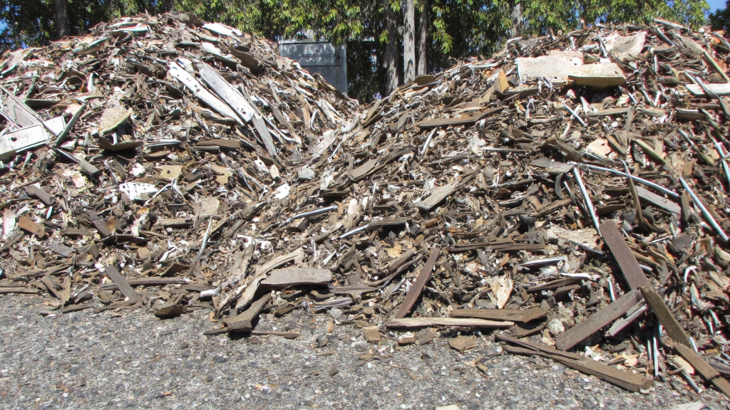 Recycled Railroad Materials Close-up of sorted piles of recycled railroad materials including steel rails, wooden ties, and metal components on an industrial site