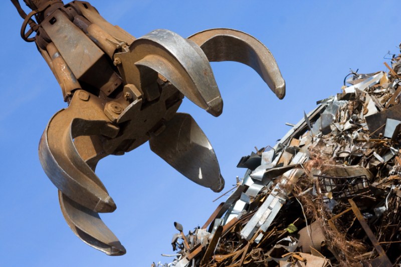 Crane being used to carry scrap metal in Dallas, TX